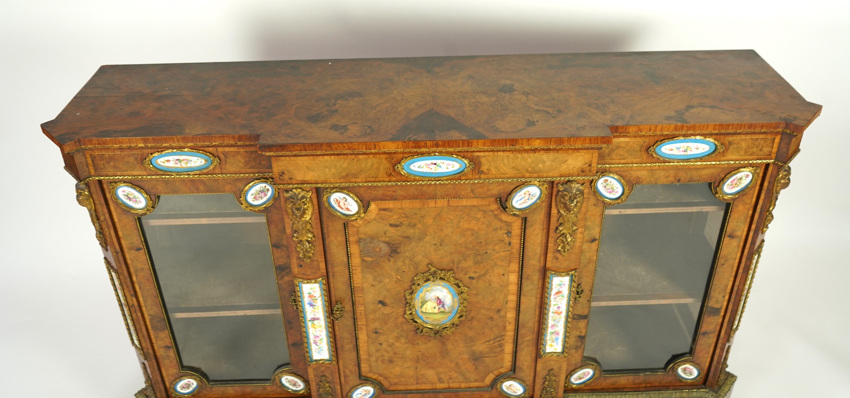 A Victorian tulip banded and gilt metal mounted walnut breakfront side cabinet